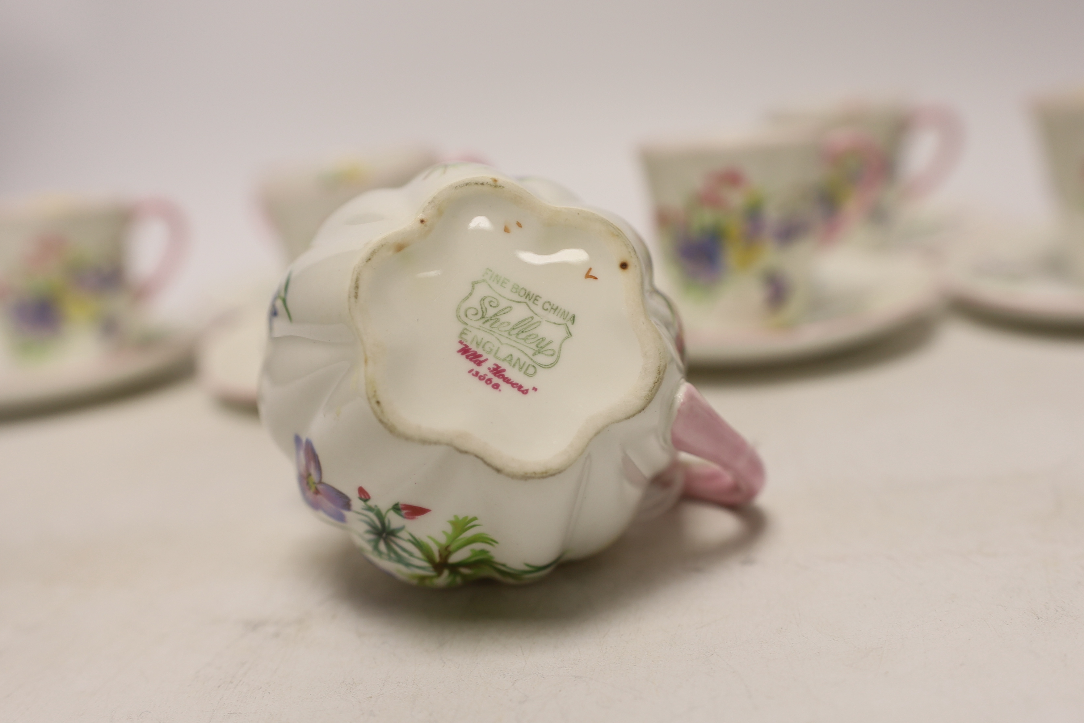 A Shelley 'wild flowers' bone china part tea set comprising milk jug and six cups and saucers